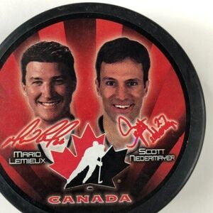 Canada Hockey Puck with Red and Black Design. Mario Lemieux